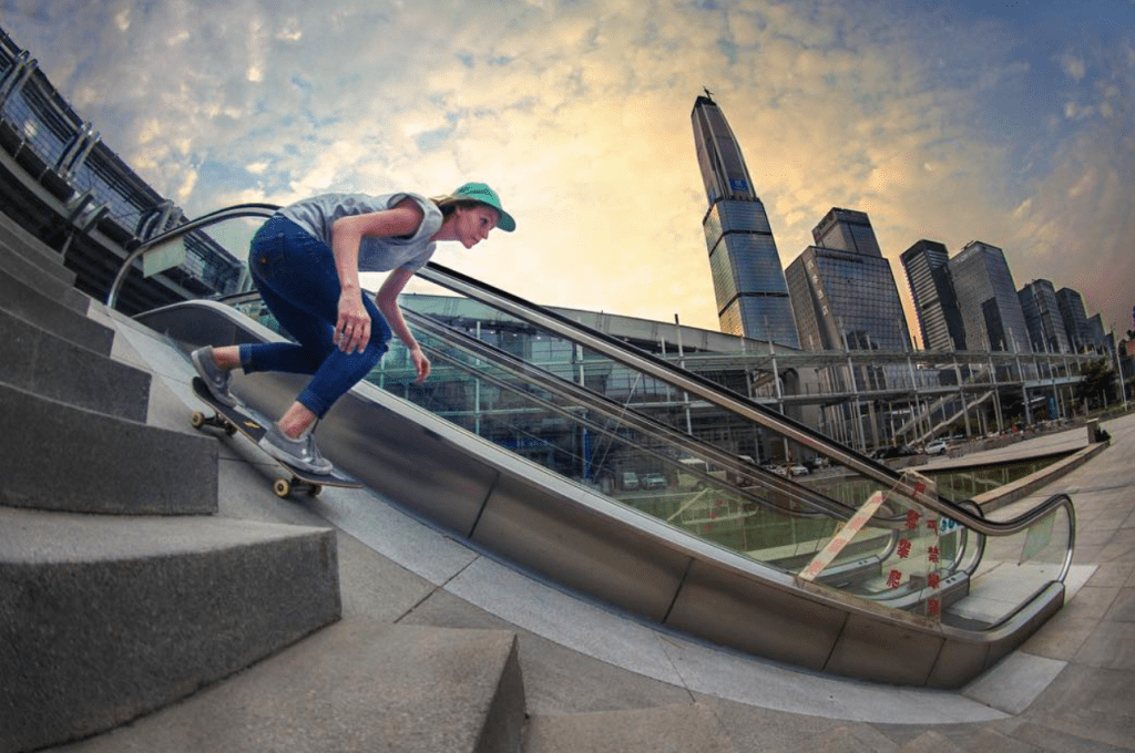 Sarah skating down ramp next to an escalator
