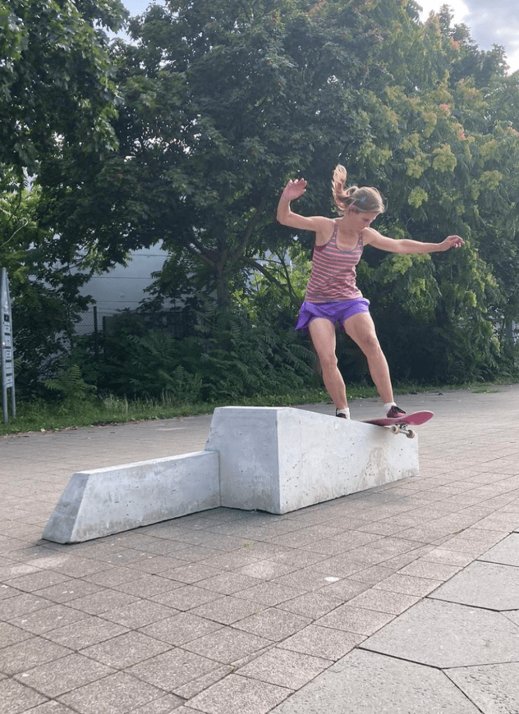 woman skating one of the skateable objects in boardslide